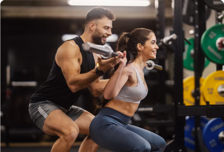 Coach helps a client do the gym workout correctly