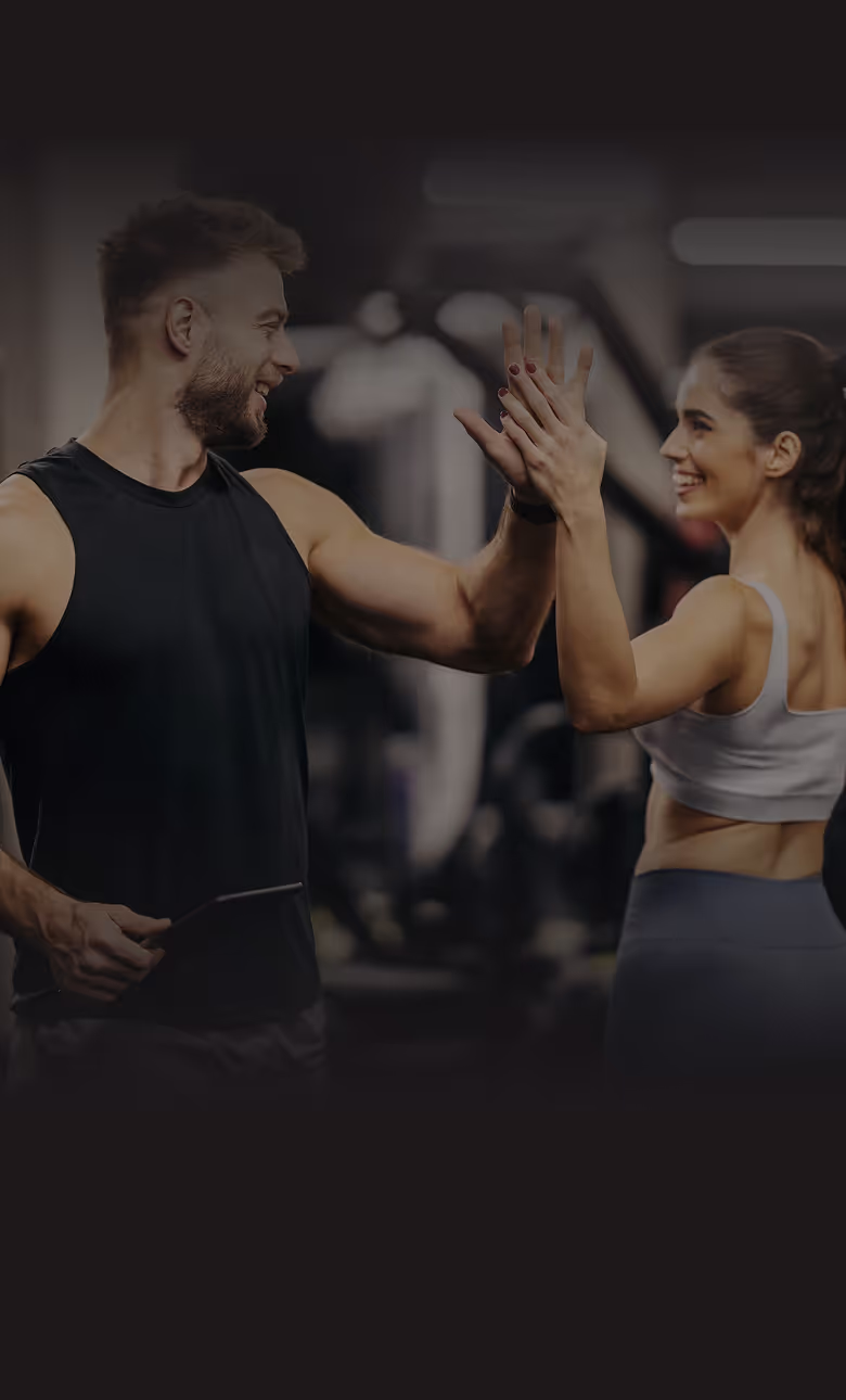 Coach high fives a client after a workout, smiling
