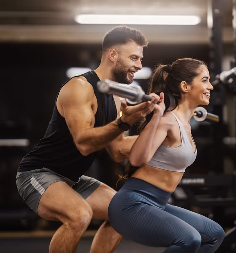 PTD coach helps client do the workout with proper form and safety
